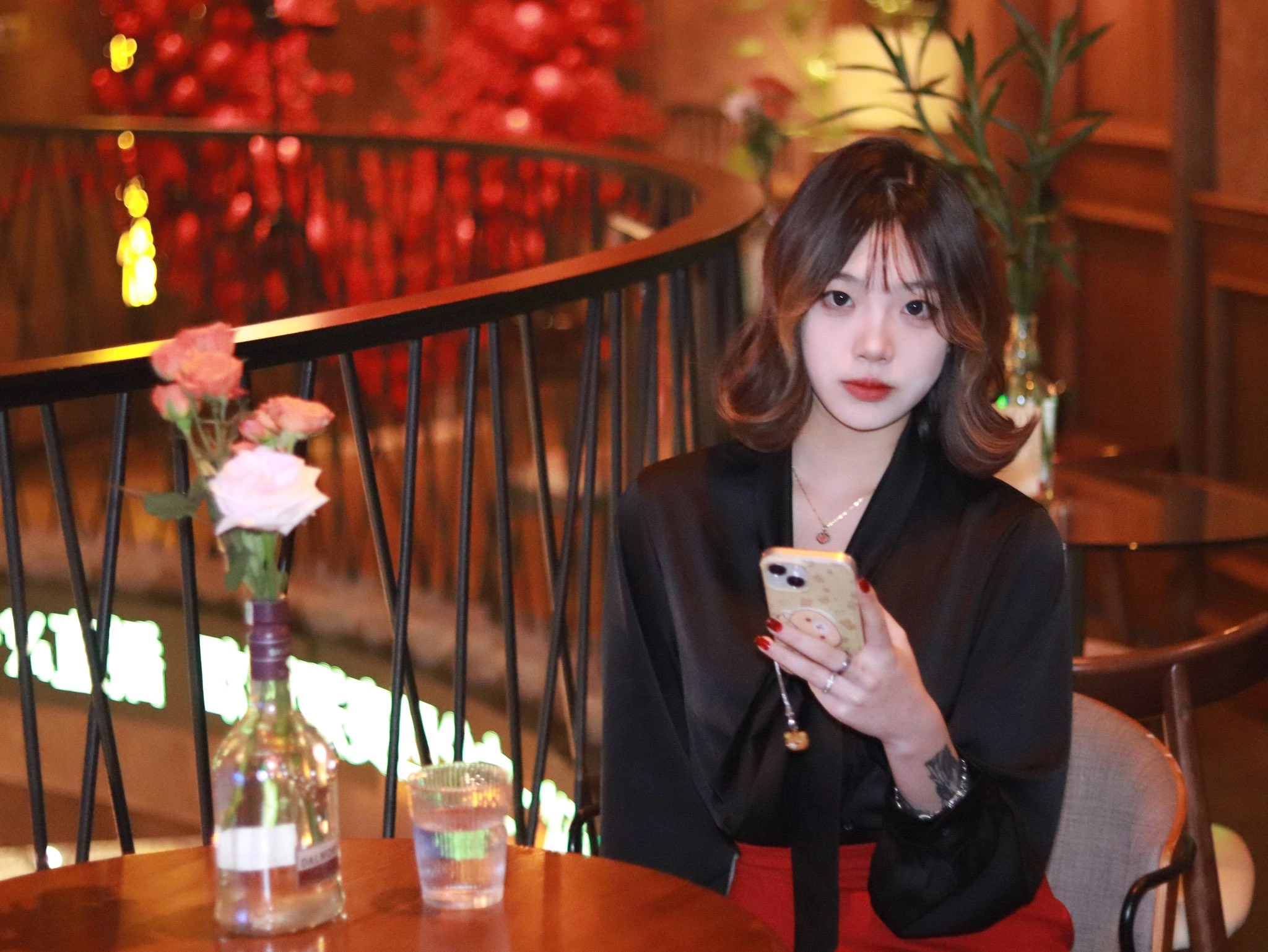 红头发和黑衬衫的女人抽一支香烟。