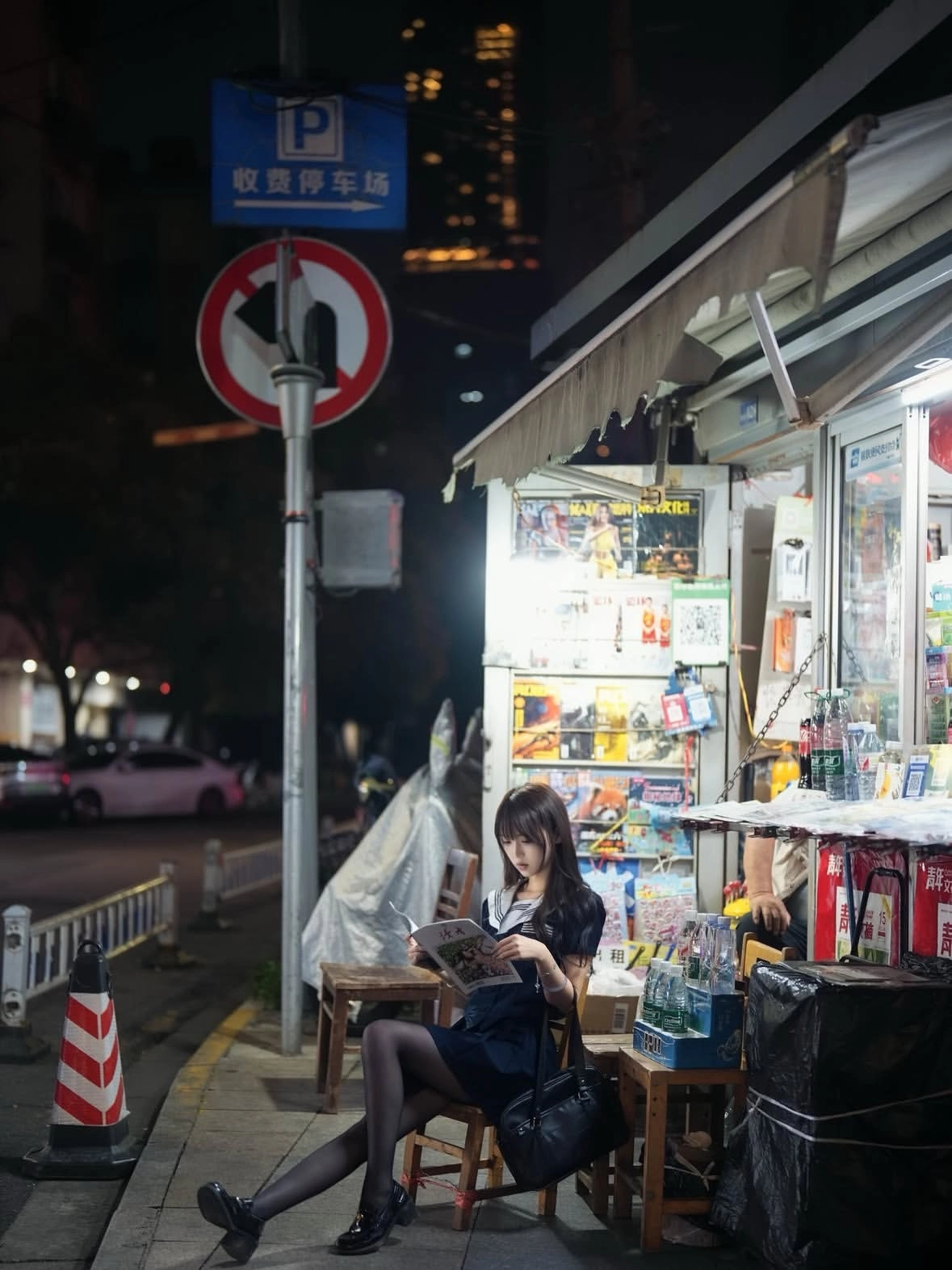 女人坐在一个圆形的物体上,拿着一本书。