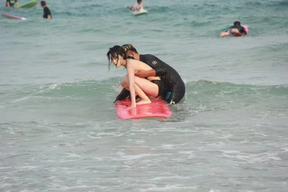 男人和一个女人在海里,一个男人抱着一个女人。